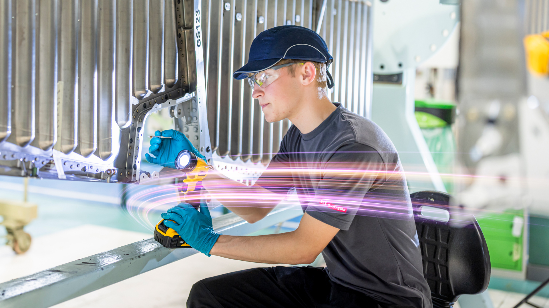 An apprentice aircraft fitter at work